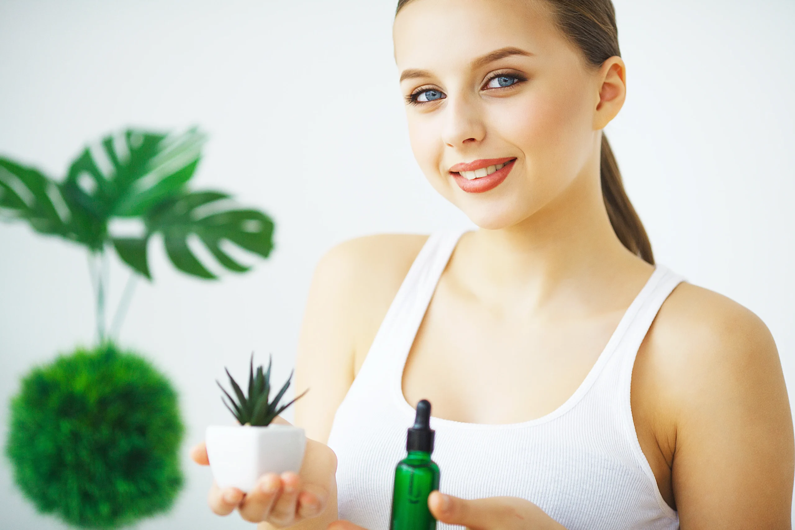 portrait young smiling woman holding green bottle with cosmetics1 scaled